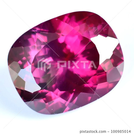 Natural gemstone red rhodolite garnet on gray background 100985014