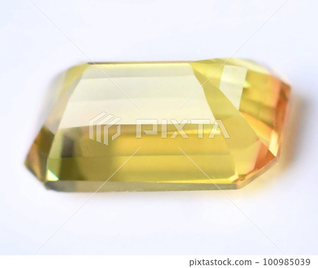 Natural gemstone yellow sapphire on gray background Natural gemstone yellow sapphire on gray background 100985039