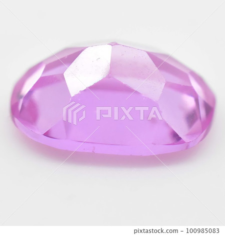 Natural gemstone pink sapphire on gray background 100985083