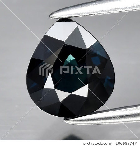 Natural gemstone blue sapphire on gray background Natural gemstone blue sapphire on gray background 100985747