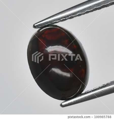 Natural precious stone noble opal on a black background Natural precious stone noble opal on a black background 100985788