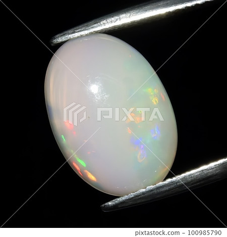 Natural precious stone noble opal on a black background Natural precious stone noble opal on a black background 100985790