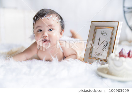 6 month old angel baby celebrating half birthday with bright natural light 6 month old angel baby celebrating half birthday with bright natural light 100985909