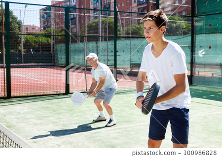 padel players of different generations playing padel court padel players of different generations playing padel court 100986828