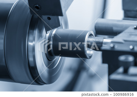 The  CNC lathe machine boring  cutting the metal shaft parts. 100986916