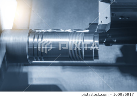 The  CNC lathe machine forming  cutting the metal shaft parts. 100986917