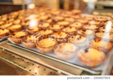Egg tart, traditional Portuguese dessert, pastel de nata on the cafe store window Egg tart, traditional Portuguese dessert, pastel de nata on the cafe store window 100987003