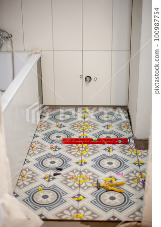 Home repairs. Laying tiles on the floor. Bathroom. Home repairs. Laying tiles on the floor. Bathroom. 100987754