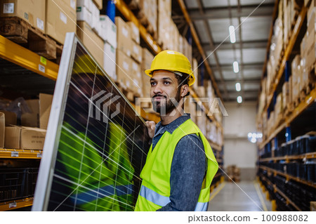 Portrait of warehouse worker carring solar panel. Portrait of warehouse worker carring solar panel. 100988082