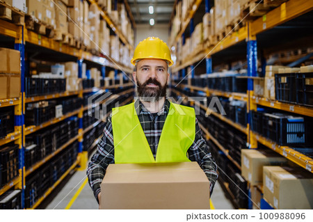 Warehouse worker stocking goods in a warehouse. 100988096
