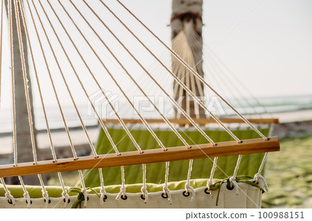Close up of hammock hanging on the palms. 100988151