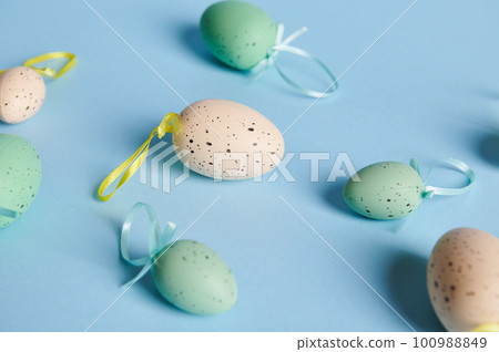Flat lay with beige and blue cyan pastel Easter eggs on isolated color background with copy advertising space. Still life. Easter celebration concept. Top view Flat lay with beige and blue cyan pastel Easter eggs on isolated color background with copy advertising space. Still life. Easter celebration concept. Top view 100988849
