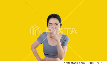 Asian woman doing silent gesture with finger, Noiseless symbol, Noisy mall, Hide a secret, Do not speak. shut your mouth, Noiseless signal transmission, Isolated on white background. Asian woman doing silent gesture with finger, Noiseless symbol, Noisy mall, Hide a secret, Do not speak. shut your mouth, Noiseless signal transmission, Isolated on white background. 100989146