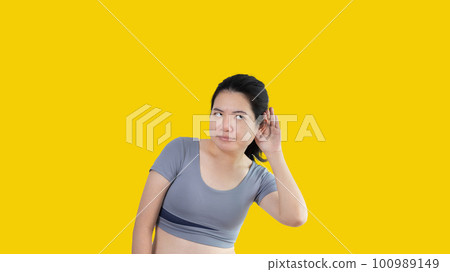 Asian woman eavesdropping or overhearing secret conversation isolated on white background, Gossip, Listening, white background studio portrait. Asian woman eavesdropping or overhearing secret conversation isolated on white background, Gossip, Listening, white background studio portrait. 100989149