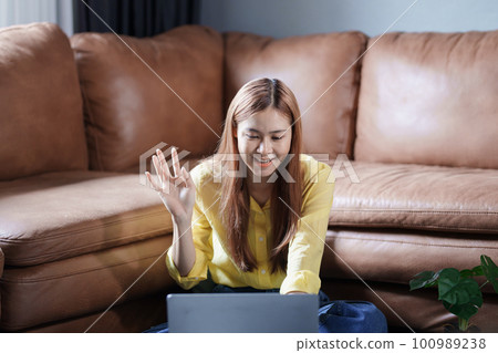 Portrait of a beautiful Asian teenage girl using a computer. Portrait of a beautiful Asian teenage girl using a computer. 100989238