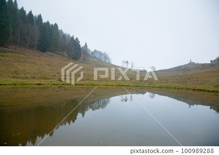 Foggy landscape from Asiago plateau trekking path Foggy landscape from Asiago plateau trekking path 100989288