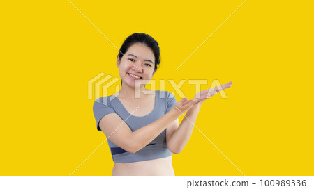 Asian woman with holding copyspace imaginary on the palm to insert an ad, Showing copyspace pointing, Showing her hand to present something on white background. 100989336