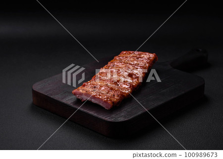 Delicious fresh grilled or smoked ribs with salt, spices and herbs Delicious fresh grilled or smoked ribs with salt, spices and herbs 100989673