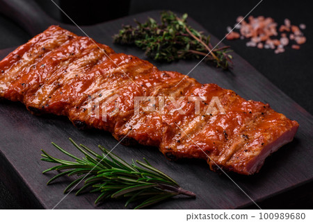 Delicious fresh grilled or smoked ribs with salt, spices and herbs Delicious fresh grilled or smoked ribs with salt, spices and herbs 100989680