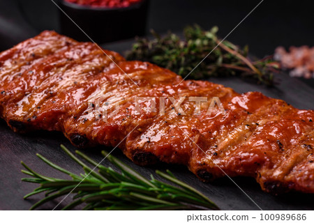 Delicious fresh grilled or smoked ribs with salt, spices and herbs Delicious fresh grilled or smoked ribs with salt, spices and herbs 100989686