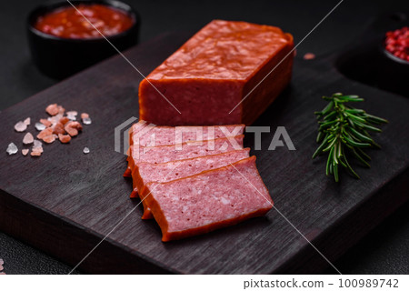 Delicious fresh sausage salami with salt, tomatoes and spices 100989742