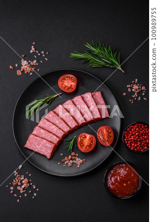 Delicious fresh sausage salami with salt, tomatoes and spices 100989755