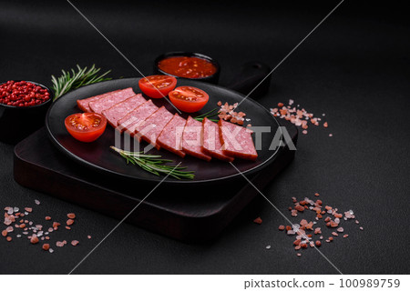 Delicious fresh sausage salami with salt, tomatoes and spices Delicious fresh sausage salami with salt, tomatoes and spices 100989759