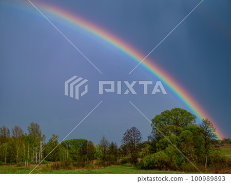 Rainbow with rain clouds in the sky. Rainbow with rain clouds in the sky. 100989893