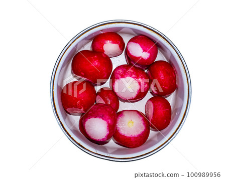Red radish vegetable in a plate on a white background. Red radish vegetable in a plate on a white background. 100989956