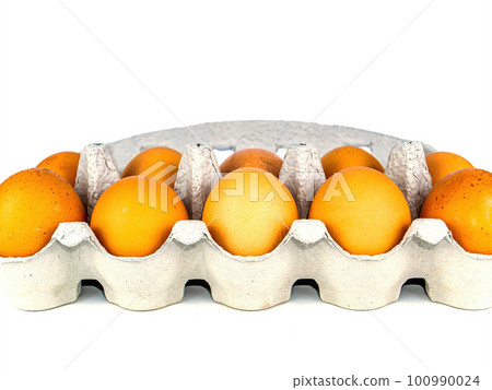 Brown chicken eggs in a carton box. Brown chicken eggs in a carton box. 100990024