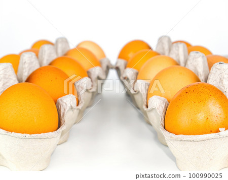 Chicken eggs in cardboard packaging on a white background. Chicken eggs in cardboard packaging on a white background. 100990025