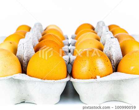 Brown chicken eggs in a carton box. 100990059