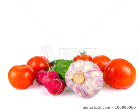 Head of garlic with cucumbers and tomatoes on a white background. Head of garlic with cucumbers and tomatoes on a white background. 100990060
