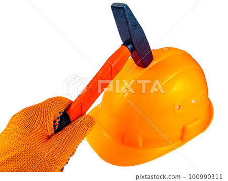 Orange protective construction helmet and iron hammer. 100990311