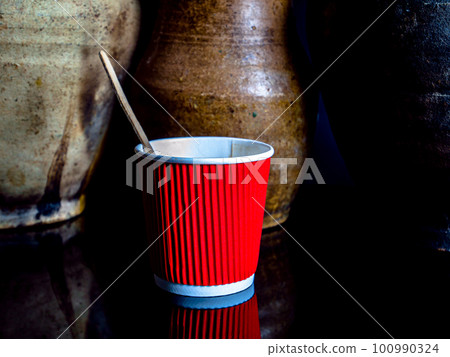 Disposable cardboard cups for coffee on a black background. 100990324