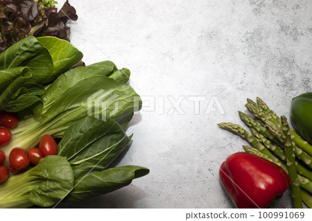Mockup Assortment Of Fresh Organic Home Grown Red Green Vegetables On Gray Granite Table. Asparagus Plant, Bell Pepper, Bok Choy, Red Leaf Lettuce, Cherry Tomatoes.Healthy food.Horizontal, copy space. 100991069