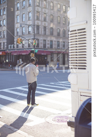 A black man trying to cross an intersection in an American city A black man trying to cross an intersection in an American city 100993417