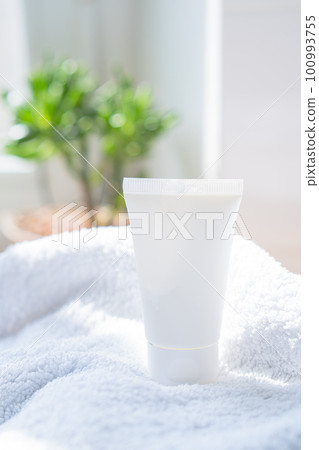 White cream tube and towel in real room interior mock-up, beauty and care product packaging template White cream tube and towel in real room interior mock-up, beauty and care product packaging template 100993755