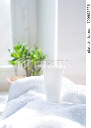 White cream tube and towel in real room interior mock-up, beauty and care product packaging template White cream tube and towel in real room interior mock-up, beauty and care product packaging template 100993756