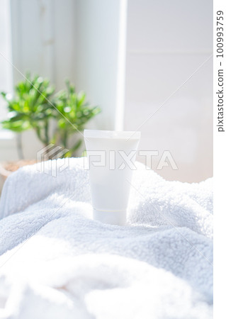 White cream tube and towel in real room interior mock-up, beauty and care product packaging template White cream tube and towel in real room interior mock-up, beauty and care product packaging template 100993759