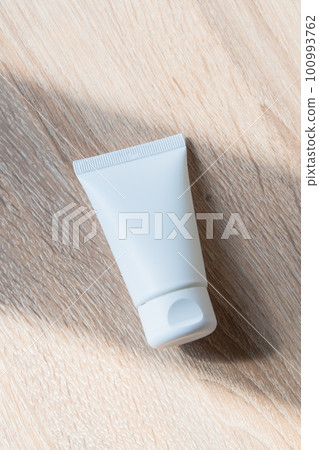 White cream tube on wooden table mock-up, beauty and care product packaging template White cream tube on wooden table mock-up, beauty and care product packaging template 100993762