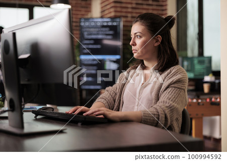 Software developer programming javascript code algorithm on computer, sitting at desk in it company office. Tech enginner working with html database script in cyber security agency. Software developer programming javascript code algorithm on computer, sitting at desk in it company office. Tech enginner working with html database script in cyber security agency. 100994592