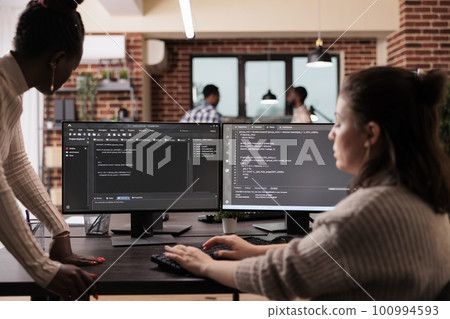 Programming engineers using computer to write code and develop algorithm program. Software developers working on user interface with html script and terminal window in development company. Programming engineers using computer to write code and develop algorithm program. Software developers working on user interface with html script and terminal window in development company. 100994593