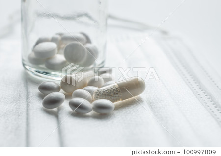 White medicine and mask Image photo of colds and illnesses 100997009