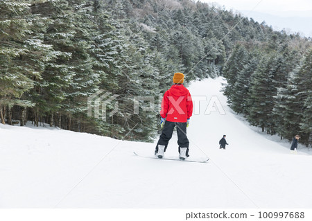 Kids enjoying snowboarding Kids enjoying snowboarding 100997688