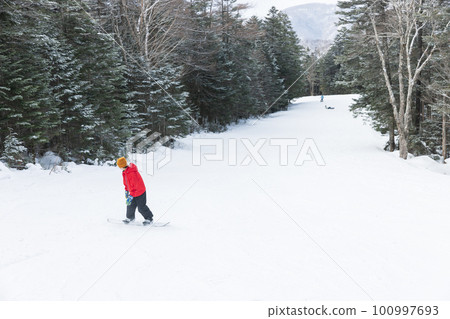 Kids enjoying snowboarding Kids enjoying snowboarding 100997693