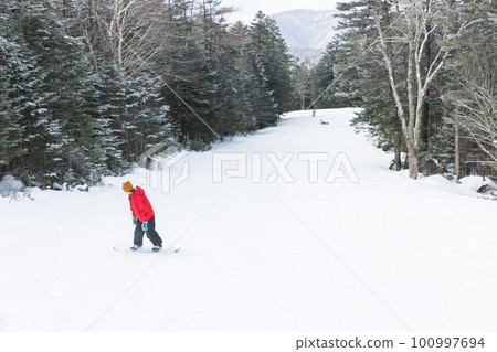 Kids enjoying snowboarding Kids enjoying snowboarding 100997694