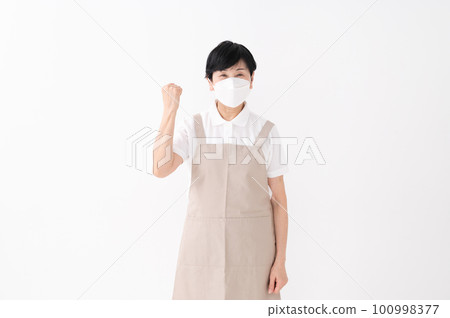 A woman in an apron with a guts pose A woman in an apron with a guts pose 100998377
