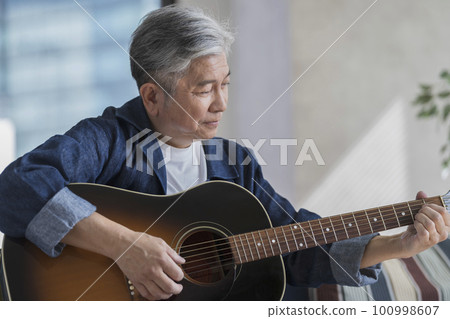 Senior men playing the guitar Senior men playing the guitar 100998607