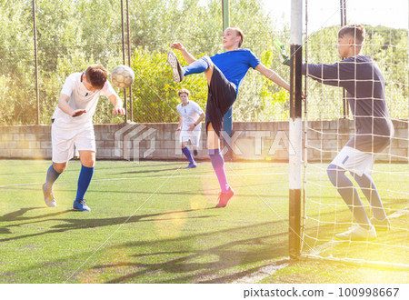 Football game - striker scores goal with his head Football game - striker scores goal with his head 100998667